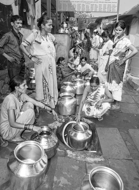 Human Right to Water in Mumbai - Impatiently waiting for their turn at a group connection in a notified slum